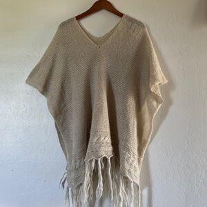 tan knitted poncho with fringe detail | size: M-L